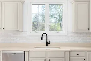 kitchen with white cabinets and a black faucet